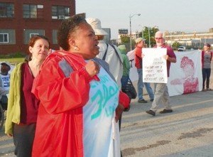 Jean Vortkamp is at left behind Monica Patrick (in red jacket) during blockade of Homrich water shut-off facility July 18, 2014.