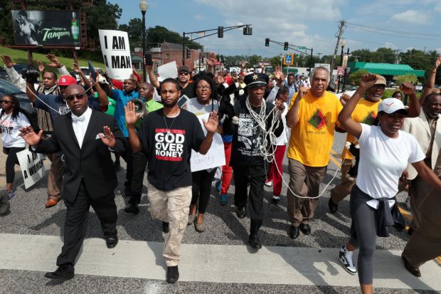 Marchers move south on S. Florissant Road in downtown Ferguson on Monday, Aug. 11, 2014 as they demonstrate at police headquarters against Saturday's police shooting of Michael Brown. Photo by Robert Cohen, rcohen@post-dispatch.com