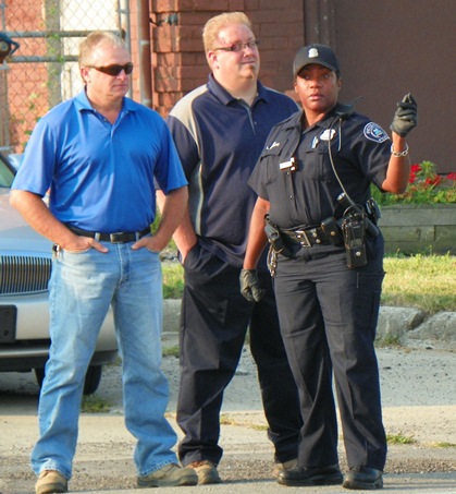 Homrich CEO Roger Homrich (center) with facility boss at left and police officer.