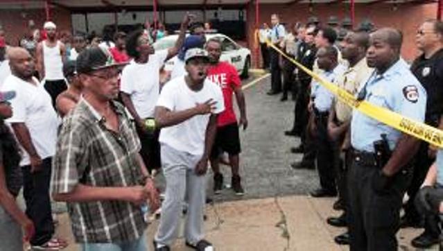 Angry crowd of hundreds confronts police in St. Louis, MO suburb after officer shot unarmed teen Michael Brown to death Aug. 9, 2014. His grandmother, who he was going to visit, saw Brown walking down the street then came upon his body. He was about to start college.