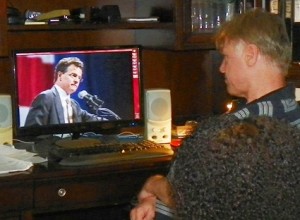 Scheid watches U.S. Congressional Candidate David Trott, owner of the largest foreclosure mill in the region, on video.
