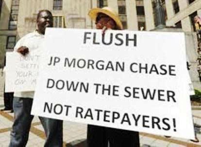 Protesters in Birmingham, Ala. protest higher rates imposed in Jefferson County bankruptcy, even though Chase was forced to take 75% debt cut.