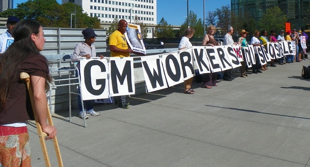 Protesters line up across from Cobo Hall as GM CEO Mary Barra speaks inside Sept. 7, 2014.