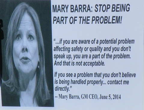 Protesters carried this sign denouncing GM CEO Mary Barra.
