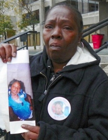 Mertilla Jones, grandmother of Aiyana, weeps as she shows the child's photo before hearing on the cop who killed her October 29, 2012.