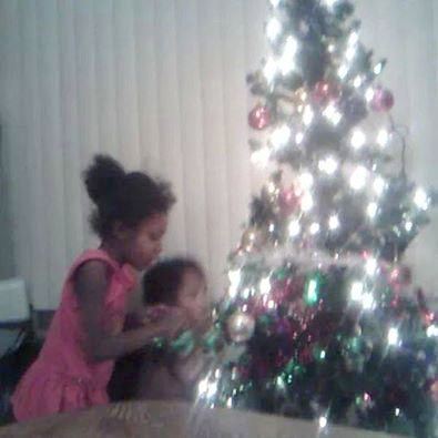 Aiyana and one of her three little brothers, all present in the home when she was killed, celebrate Christmas during happier days.