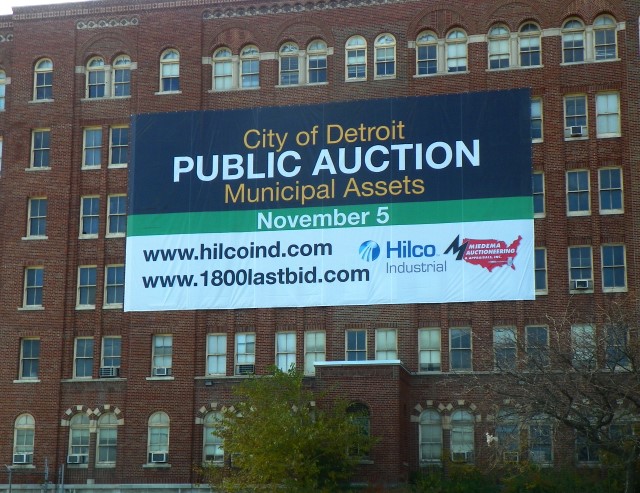 Detroit "public auction" advertised on freeway side of now abandoned Herman Kiefer Health Complex.