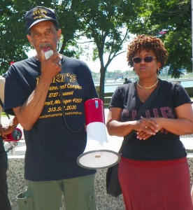 Bert Dearing, Jr. (l) speaks at rally in Hart Plaza July 21, 2015, as Bert's Marketplace was being auctioned off.