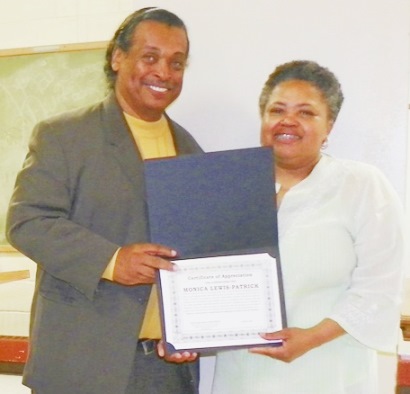 DAREA Pres. Bill Davis presents award to activist Monica Lewis Patrick of We the People of Detroit at DAREA prayer breakfast June 27, where petition campaign to save DWSD was kicked off.
