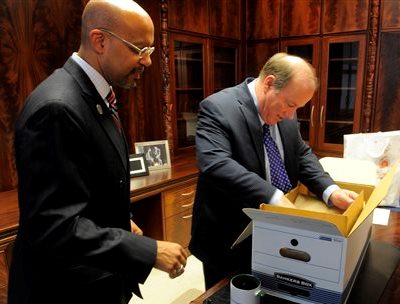 Butch Hollowell, new house "N," helps "mayor" Mike Duggan move into his office.