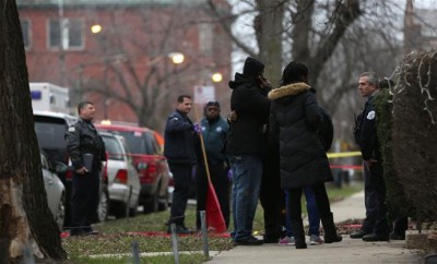 Chicago police officers talk with relatives of one of the two people killed by a police officer.