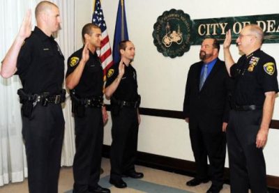 Mayor Jack O’Reilly with Dearborn Police Chief Ronald Haddad swear in new recruits (l to r) Bryan Fox, Christopher Hampton, and Andrew Galuska. July 24, 2010/Dearborn Press and Guide