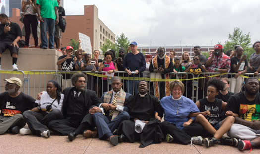Cornel West (third from l) and others engage in civil disobedience outside federal courthouse in St. Louis. West and others were later arrested. FC photo