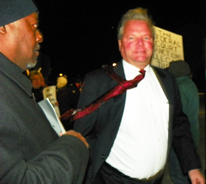 Wealthy white male rushes past protesters Nov. 19.