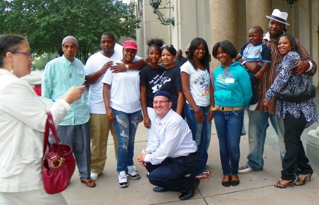 Davontae Sanford family and supporters after appeals court hearing August 6, 2013. Mother Taminko Sanford Tilmon and stepfather Jermaine Tilmon at right; paralegal Roberto Guzman in front; Detroit News reporter Oralandar Brand Williams at left taking photos.jpg