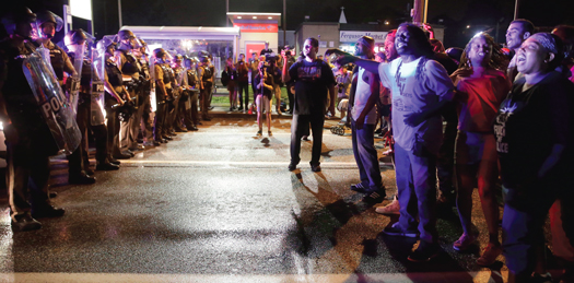 Protesters face off against police on West Florissant, where Michael Brown died. FC photo