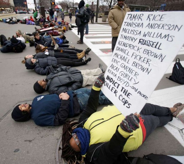 Demonstrators lie down in Public Square.