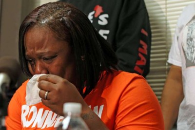Dorothy Holmes, mother of Ronald Johnson, weeps after cop who killed her son is not charged.