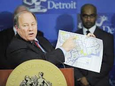 Duggan pointing out selected areas of Detroit that will have taxes decreased.