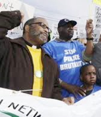 Father Ellis Clifton (l)protests with Floyd Dent and grandson at head of march April 2, 2015.