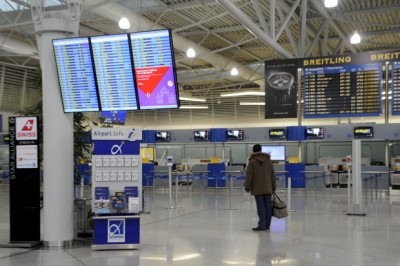 A passenger looks at an announcement board inside the Athens Eleftherios Venizelos International Airport, as flight controllers hold a work stoppage during a 24-hour general strike against planned pension reforms in Thursday. (Michalis Karagiannis/Reuters)