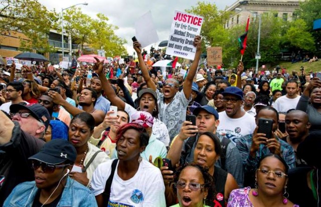 Demonstrators flooded streets in New York City, Oakland, CA and other places across the country after grand jury refused to indict NYPD killer cop in Eric Garner murder.
