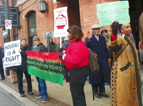 Dr. Sandra Simmons (r) and Prof. Charles Simmons (in cap) of HUSH House join protest: HOUSING IS A HUMAN RIGHT!