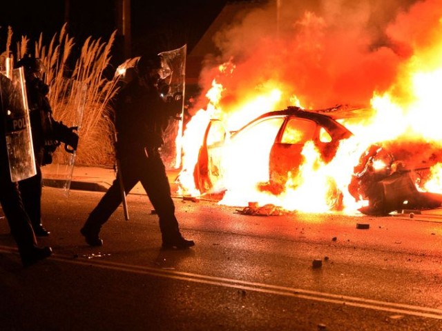 Ferguson police car burns Nov. 24 after grand jury verdict announced.