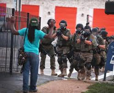 Military occupation at home: Teen confronts police in Ferguson, MO after the police execution of Michael Brown Aug. 9, 2014. His killer, Darren Wilson, was exonerated.