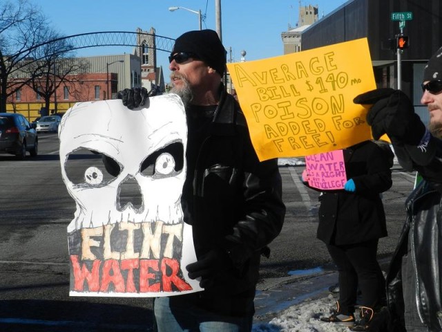 Protesters at Flint city hall in January. Flint's Emergency Manager ordered the city to disconnect from the Detroit Water & Sewerage Dept. and establish its own water treatment facilities. Residents have since complained of  polluted water, higher rates.