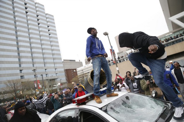 Freddie Gray protesters attacked police cars. Photo: Shannon Stapleton/Reuters.