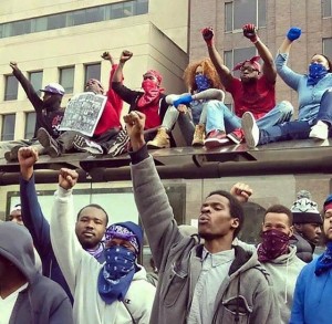 Protesters against death of Freddie Gray take to roofs. Despite allegations that people from outside Baltimore controlled the protests, photos like these showed differently. Protesters were prepared for attacks by police. Thirty-four were arrested.