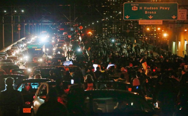 NYC protesters block traffic on Brooklyn Bridge.