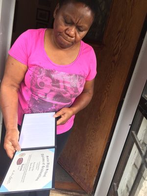 Gwen Drisdel, Tyrone Harris, Jr's grandmother, shows his high school diploma to St. Louis Post-Dispatch reporter. She told him, "I don’t believe he would disrespect police like that. There was a lot of  confusion, and it was very dark. . . .I know his girlfriend said he was running from the shooting toward her car, and where the plainclothesmen were. He was running from the bullets; I'm not even sure he knew he was encountering police.”