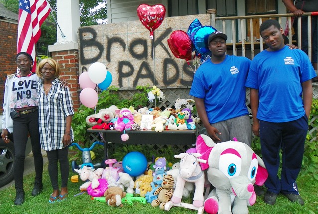 (L to r) The children's great-grandmother Marie Jackson, grandmother Nicole Jackson, and uncles Delvontie and Justin Thompson at memorial set up in front of Jackson home on Nottingham. 