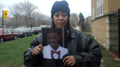 Janet Cooksey with photo of her son, Quintonio LeGrier, 19.