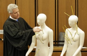 Cuyahoga County Judge John P. O'Donnell examines mannikins representing Timothy Russell and Malissa Williams during trial.