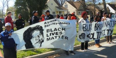 Protesters marched with a banner remembering Aiyana on April 28, 2015, after police killed Terrance Kellom, 19, in his father's home.