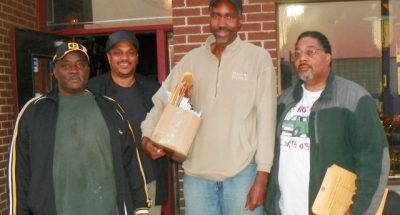 Cornell Squires (rear) interviewed and reported on massive lay-offs taking place in the Detroit Water and Sewerage Dept. He is shown here with (l to r) laid-off workers Sammy Barber, Edward Collins, and Dean E. Fox Sr. after interview at Bert's. 