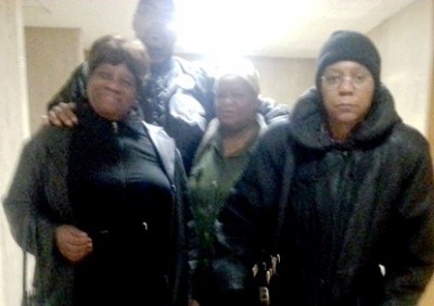 Lennette Williams (center), with attorney Vanessa Fluker at right, supporters Arnetta Grable (l) and Min. Malik Shabazz (top) after court hearing Nov. 19, 2014
