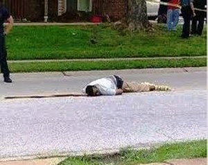 Mike Brown's body lying in street for four hours after he was killed, as agonized family members and neighbors watched.