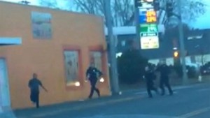 In this still frame taken from a cell phone video provided by Dario Infante and taken on Feb. 10, 2015, Antonio Zambrano-Montes, left, turns to face police officers while running from them in Pasco, Wash. Moments later, Zambrano-Montes was shot and killed. Pasco police said he threw multiple rocks, hitting two officers, and refused to put down other stones. (AP Photo/Dario Infante)   AP