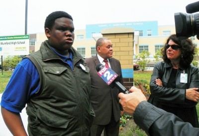 Student at Mumford High School, then part of the EAA, tells media about terrible conditions there May 28, 2013 as Board President Herman Davis and member Elena Herrada listen.