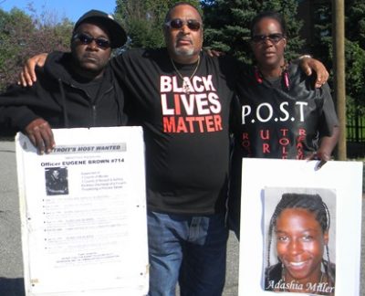 Kevin Kellom, Pastor Jerome McCorry, and Yolanda McNair, leader of P.O.S.T., holding poster with her daughter Adaisha Miller's photo.