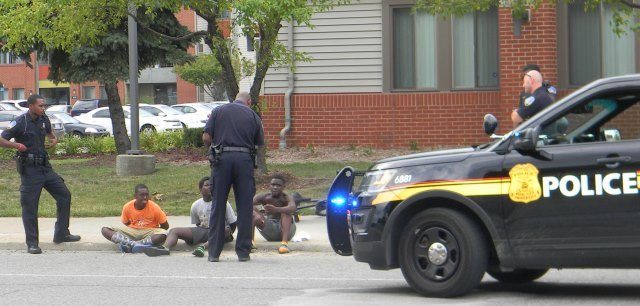 Several police cars converged on three Black children near Wayne State's campus Aug. 14, 2016, handcuffing them and questioning them for an extended period. This photographer called out: "Why are you harassing these children?" and brought attention to the incident by speaking with a nearby coach handling basketball practice at a church. They were eventually released.