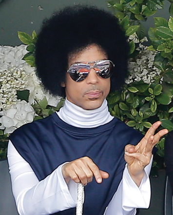 In this June 2, 2014, file photo, U.S. pop singer Prince watches the fourth round match of the French Open tennis tournament between Spain’s Rafael Nadal and Serbia’s Dusan Lajovic at the Roland Garros stadium, in Paris. Prince announced on, Aug. 25, 2014, that he would release a new album entitled, “Art Official Age” on Warner Bros. Records, the label Prince was signed to from 1978 to the mid-1990s, but later battled for the rights of his music. Photos: AP/ Wide World photos