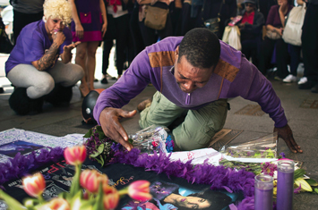 A fan cries at a makeshift memorial created in remembrance of singer Prince outside Apollo Theatre in New York , April 22.