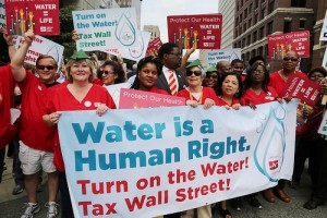 Nurses help lead last years' massive march against water shutoffs in downtown Detroit, July 18, 2014.