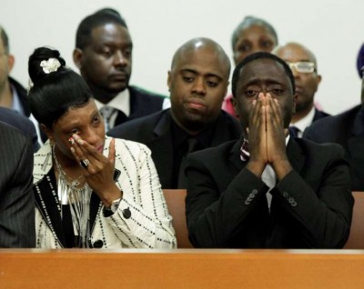 Ramarley's mother Constance Malcolm and father Franclot Graham weep at press conference. His father sang to him as a baby, "Ramarley Charley, you are my Charley Ramarley." His nickname became Charley.