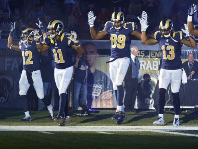 Louis Rams wide receiver Stedman Bailey (12), wide receiver Tavon Austin (11), tight end Jared Cook (89), wide receiver Chris Givens (13) and wide receiver Kenny Britt (81) put their hands up to show support for Michael Brown before a game against the Oakland Raiders at the Edward Jones Dome.(Photo: Jeff Curry, USA TODAY Sports)